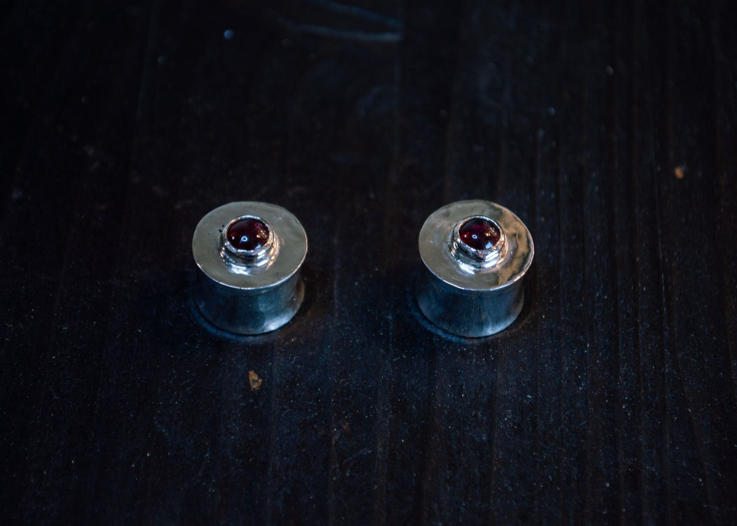 Silver ear plugs with garnet