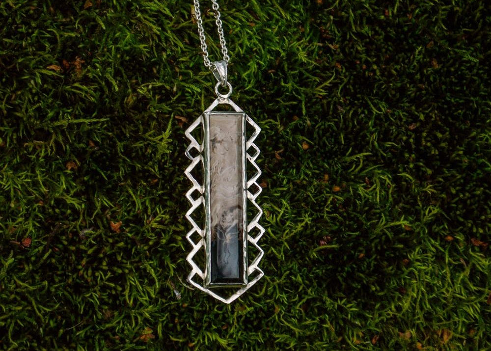 Silver pendant with petrified palm roots