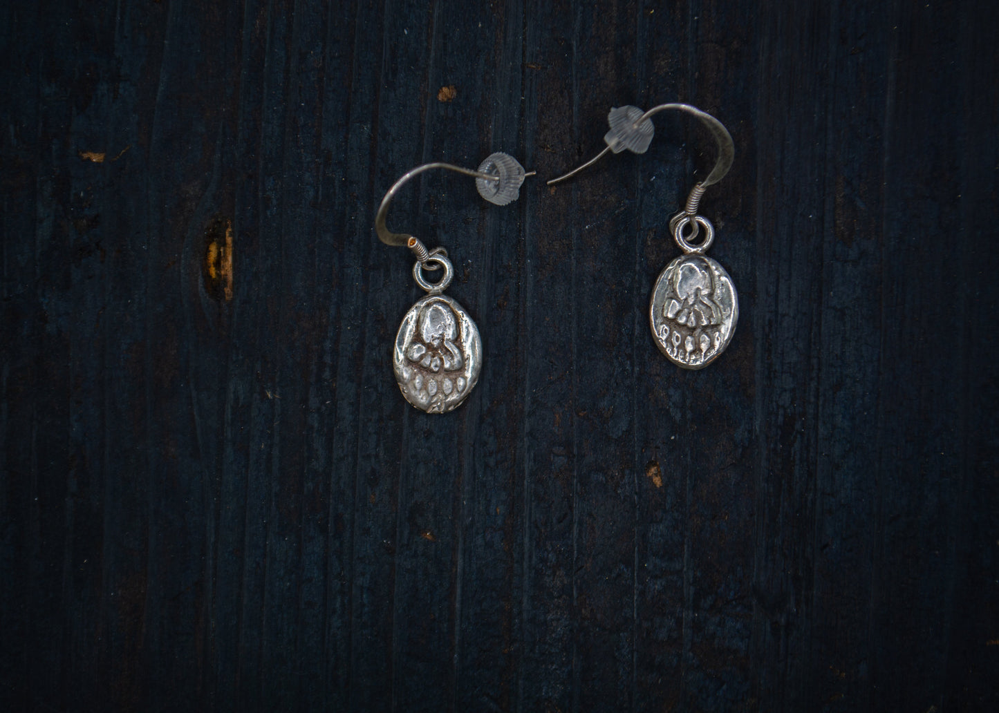 Silver earrings with a bear pawn motif