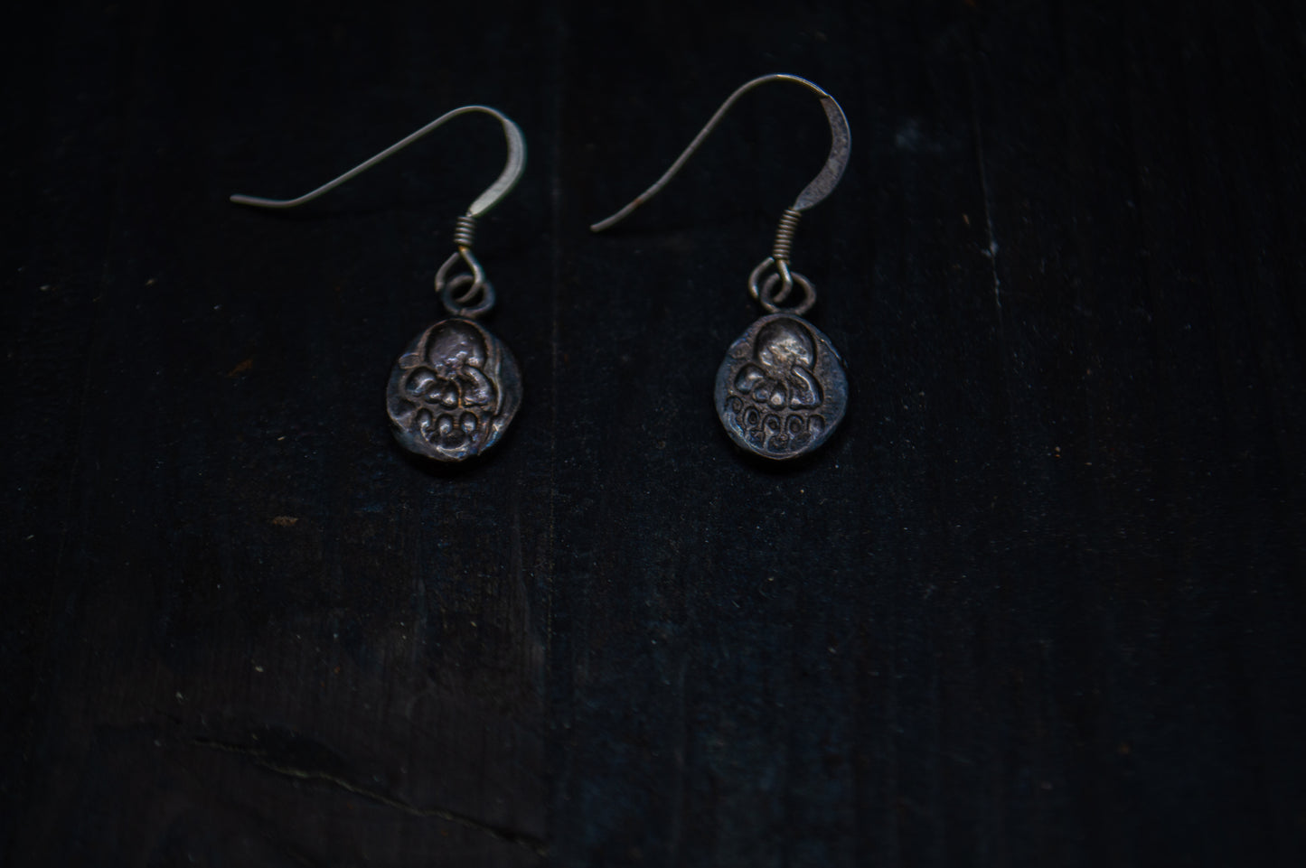Silver earrings with a bear pawn motif