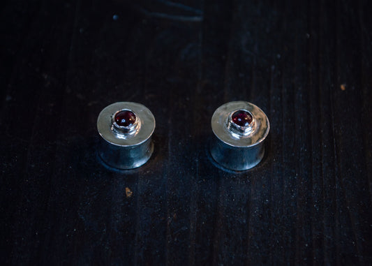 Silver ear plugs with garnet