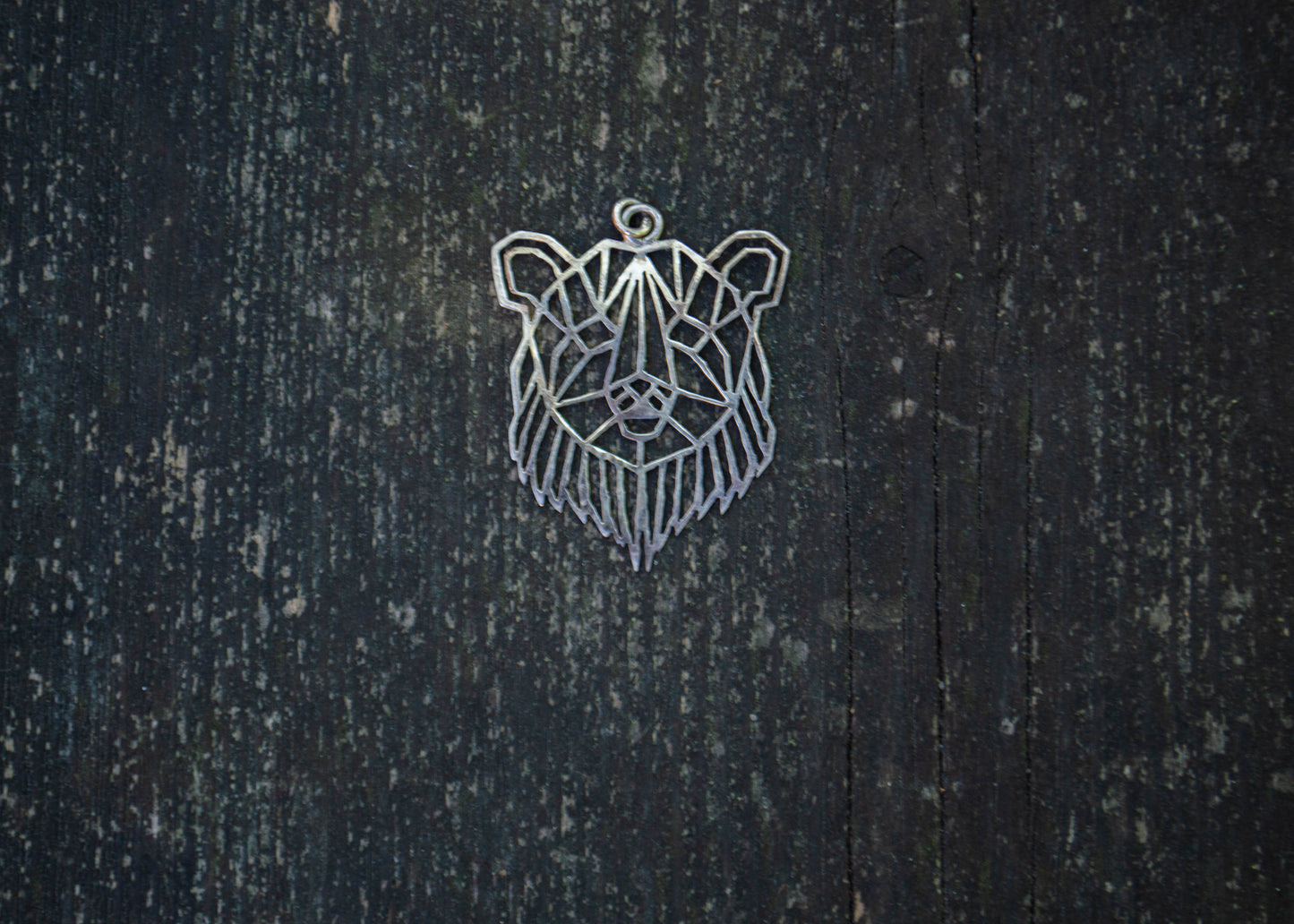 Silver pendant with a bear motif