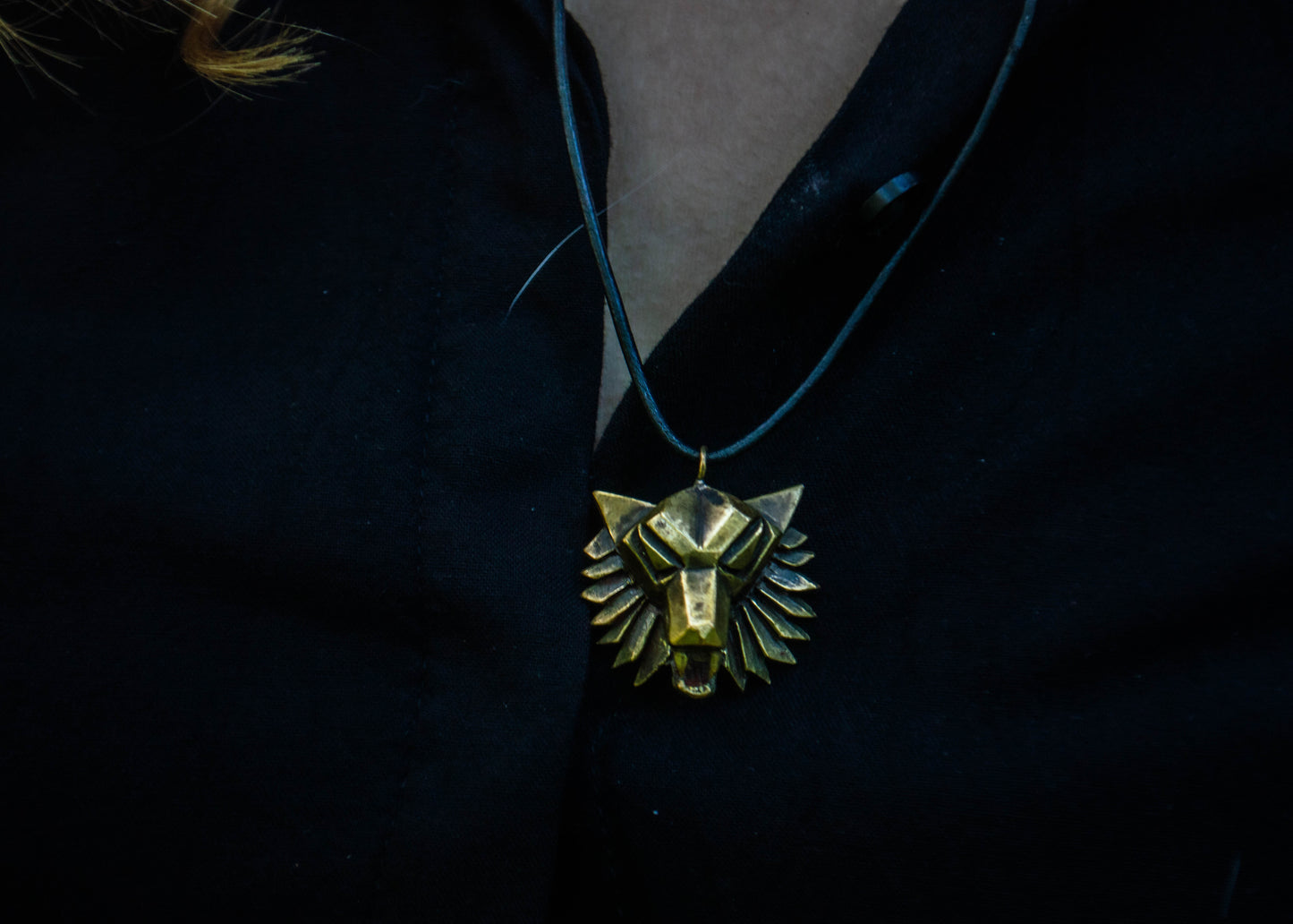 Brass pendant with a wolf motif