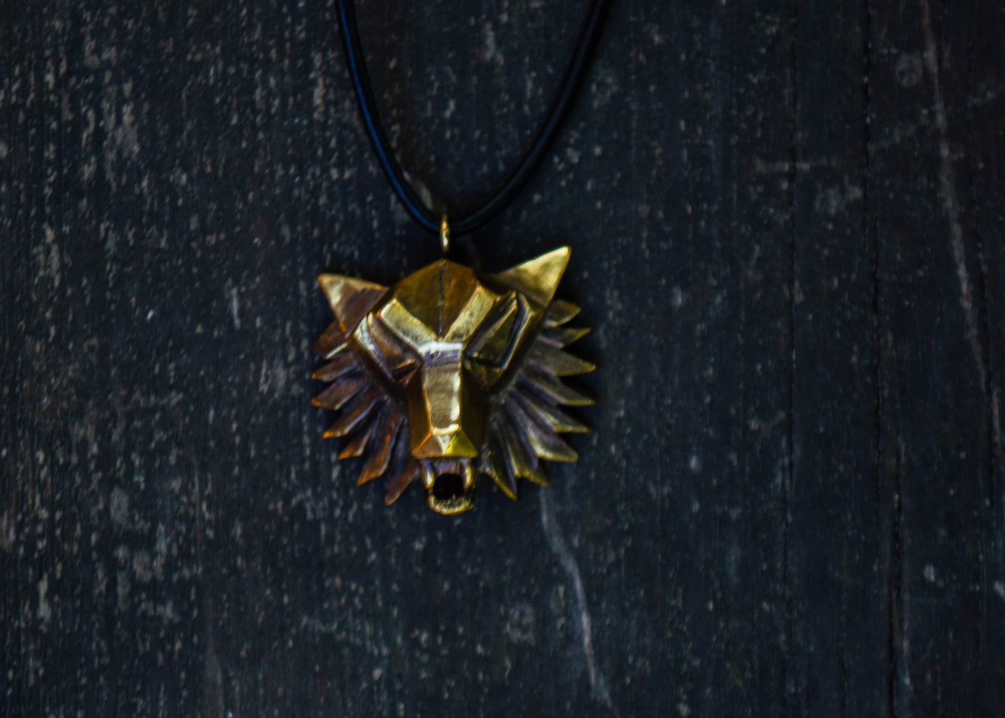 Brass pendant with a wolf motif