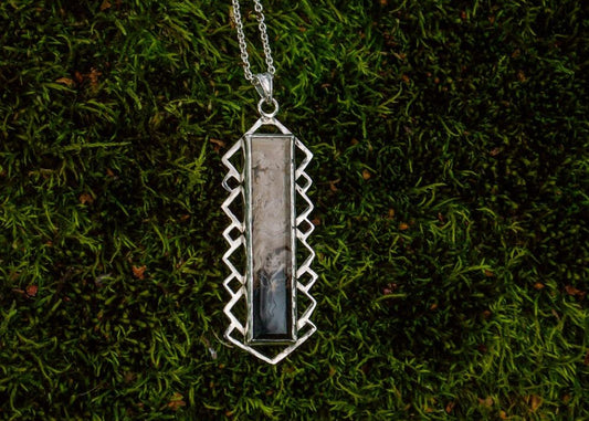 Silver pendant with petrified palm roots